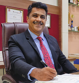 a man in a suit smiling,Dr.Vishal Wadajkar